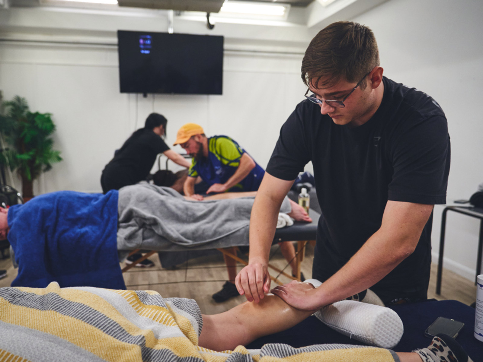 Future Fit team providing sports massage to athletes on massage beds.